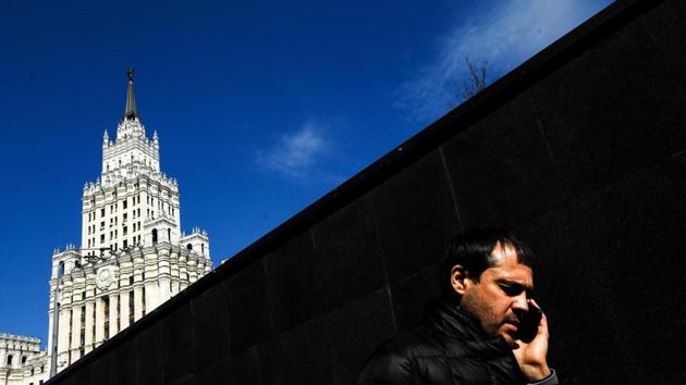 A man speaks on a mobile phone while walking out of an underground passage on a sunny day in Moscow, Russia. (Kirill Kurdyavtsev / AFP) 