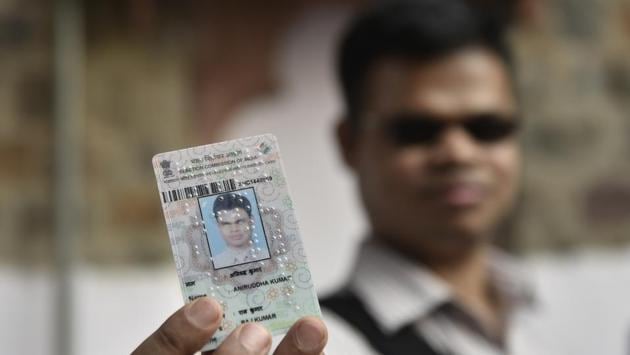 The Delhi CEO office said in a statement that all visually impaired voters are being provided identity cards in braille. Here Kumar poses for a photograph with his voter card. (Sanchit Khanna / HT Photo)