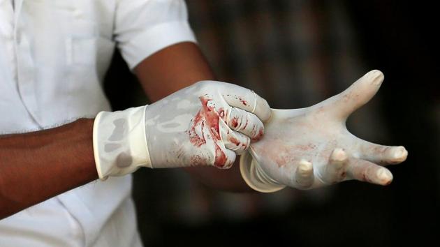 Blood on gloves of a police mortuary official is seen as he waits for casualties. Silva said he saw horrible scenes, body parts strewn all over. Emergency crews are at all locations in full force. President Maithripala Sirisena has appealed for calm and Prime Minister Ranil Wickremesinghe termed the blasts as cowardly attacks. (Dinuka Liyanawatte / REUTERS) Blood on gloves of a police mortuary official is seen as he waits for casualties. Silva said he saw horrible scenes, body parts strewn all over. Emergency crews are at all locations in full force. President Maithripala Sirisena has appealed for calm and Prime Minister Ranil Wickremesinghe termed the blasts as cowardly attacks. (Dinuka Liyanawatte / REUTERS)
