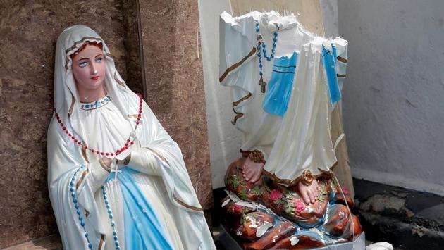 A statue of Virgin Marry broken in two parts is seen. The first blasts were reported at St Anthony’s church and St Sebastian’s Church just outside the capital. “A bomb attack to our church, please come and help if your family members are there,” read a post on the Facebook page of the St Sebastian’s Church. The blasts were followed by explosions at three hotels in Colombo and the church in Batticaloa. (Dinuka Liyanawatte / REUTERS) A statue of Virgin Marry broken in two parts is seen. The first blasts were reported at St Anthony’s church and St Sebastian’s Church just outside the capital. “A bomb attack to our church, please come and help if your family members are there,” read a post on the Facebook page of the St Sebastian’s Church. The blasts were followed by explosions at three hotels in Colombo and the church in Batticaloa. (Dinuka Liyanawatte / REUTERS)