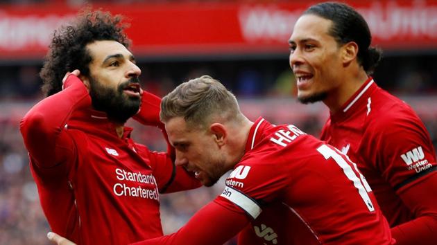 Liverpool's Mohamed Salah celebrates scoring their second goal with Jordan Henderson and Virgil van Dijk.(REUTERS)