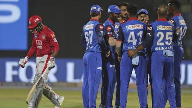 Kings XI Punjab batsman Mayank Agarwal, left, walks back as Delhi Capitals players celebrate his dismissal. (AP) Kings XI Punjab batsman Mayank Agarwal, left, walks back as Delhi Capitals players celebrate his dismissal. (AP)