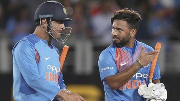 India's MS Dhoni, left, and Rishabh Pant talk after the end of a match.(AP)