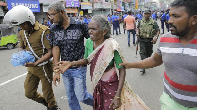 An elderly woman is helped near St. Anthony’s Shrine after the explosion. The blasts targeted St Anthony’s Church in Colombo, St Sebastian’s Church in the western coastal town of Negombo and another church in the eastern town of Batticaloa around 8.45 a.m. (local time) as the Easter Sunday mass were in progress. (Eranga Jayawardena / AP) An elderly woman is helped near St. Anthony’s Shrine after the explosion. The blasts targeted St Anthony’s Church in Colombo, St Sebastian’s Church in the western coastal town of Negombo and another church in the eastern town of Batticaloa around 8.45 a.m. (local time) as the Easter Sunday mass were in progress. (Eranga Jayawardena / AP)