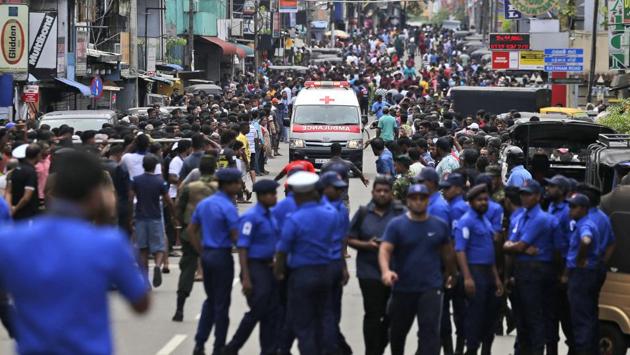 Police officers clear the road as an ambulance drives through carrying the injured. Harsha de Silva, Sri Lanka’s Minister of Economic Reforms and Public Distribution, said that there have been “many casualties including foreigners.” “45 people died in Colombo where three hotels and a church were hit, while more than 90 were killed in Negombo and 27 in Batticaloa,” hospital sources said, adding that more than 450 people were injured in the blasts. (Eranga Jayawardena / AP) Police officers clear the road as an ambulance drives through carrying the injured. Harsha de Silva, Sri Lanka’s Minister of Economic Reforms and Public Distribution, said that there have been “many casualties including foreigners.” “45 people died in Colombo where three hotels and a church were hit, while more than 90 were killed in Negombo and 27 in Batticaloa,” hospital sources said, adding that more than 450 people were injured in the blasts. (Eranga Jayawardena / AP)