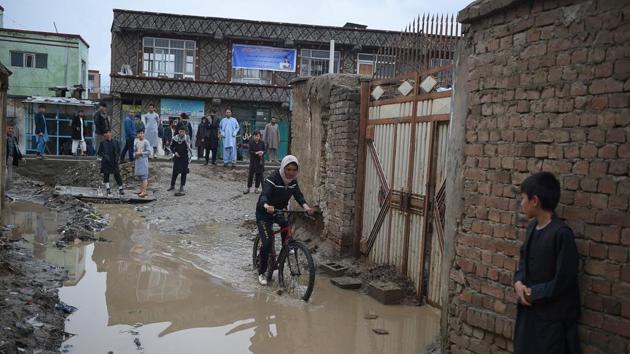 Kobra Samim rides her bicycle through a flooded street in Kabul. Before being toppled by the US invasion of 2001, the Taliban governed Afghanistan for nearly five years with a strict interpretation of sharia law. Women were confined to their homes, forced to wear burqas and forbidden from going to school. Some were publicly stoned to death on flimsy allegations of adultery. (Wakil Kohsar / AFP) Kobra Samim rides her bicycle through a flooded street in Kabul. Before being toppled by the US invasion of 2001, the Taliban governed Afghanistan for nearly five years with a strict interpretation of sharia law. Women were confined to their homes, forced to wear burqas and forbidden from going to school. Some were publicly stoned to death on flimsy allegations of adultery. (Wakil Kohsar / AFP)