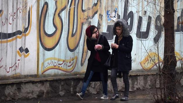 Afghan girls walk next to graffitis on a wall in Kabul. The United States is holding direct talks with Taliban leaders -- all men --- in a bid to forge a peace deal. Two Afghan women were invited to informal talks in Moscow in February between the Taliban and Afghan representatives, but their presence was very peripheral. (Wakil Kohsar / AFP) Afghan girls walk next to graffitis on a wall in Kabul. The United States is holding direct talks with Taliban leaders -- all men --- in a bid to forge a peace deal. Two Afghan women were invited to informal talks in Moscow in February between the Taliban and Afghan representatives, but their presence was very peripheral. (Wakil Kohsar / AFP)