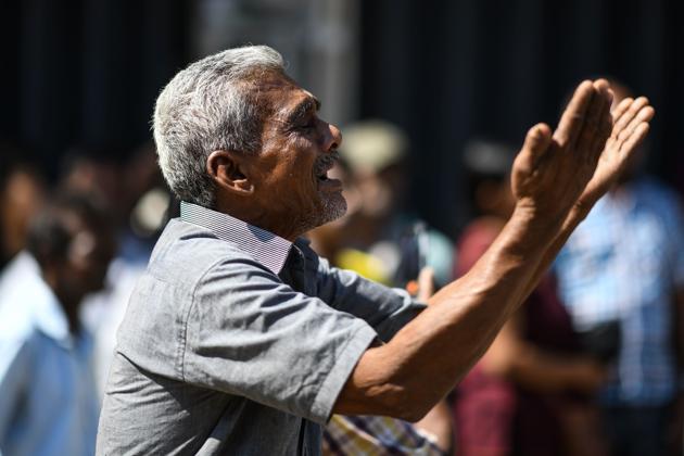 A man cries as he prays outside the St. Anthony's Shrine in Colombo on April 22, 2019, a day after the building was hit as part of a series of bomb blasts targeting churches and luxury hotels in Sri Lanka.(AFP)