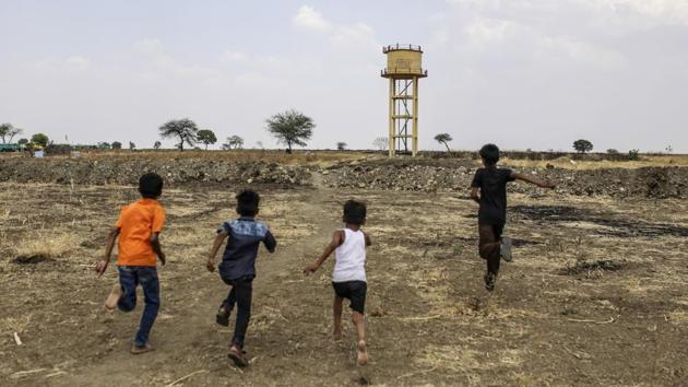 Boys run towards an empty water tank standing on farmland near the village of Khardewadi. Modi’s BJP had earlier pledged to make Maharashtra drought free this year. The project called Jalyukt Shivar Abhiyaan accelerated the building of dams, ponds and tanks to store water. (Dhiraj Singh / Bloomberg) Boys run towards an empty water tank standing on farmland near the village of Khardewadi. Modi’s BJP had earlier pledged to make Maharashtra drought free this year. The project called Jalyukt Shivar Abhiyaan accelerated the building of dams, ponds and tanks to store water. (Dhiraj Singh / Bloomberg)