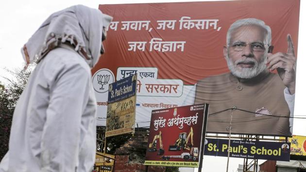 A pedestrian walks past a BJP election campaign hoarding featuring Narendra Modi in Beed. The main opposition Congress party is appealing to those feeling left behind under Modi. “We have an anger index that calculates a voter’s disillusionment against the current regime,” said Praveen Chakravarty, head of Congress’s data analytics department. “The index in January suggested that Maharashtra is the angriest state in India.” (Dhiraj Singh / Bloomberg) A pedestrian walks past a BJP election campaign hoarding featuring Narendra Modi in Beed. The main opposition Congress party is appealing to those feeling left behind under Modi. “We have an anger index that calculates a voter’s disillusionment against the current regime,” said Praveen Chakravarty, head of Congress’s data analytics department. “The index in January suggested that Maharashtra is the angriest state in India.” (Dhiraj Singh / Bloomberg)