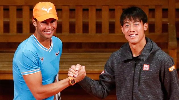 Spain's Rafael Nadal (L) shakes hands with Japan's Kei Nishikori at the Palau de la Musica in Barcelona.(AFP)