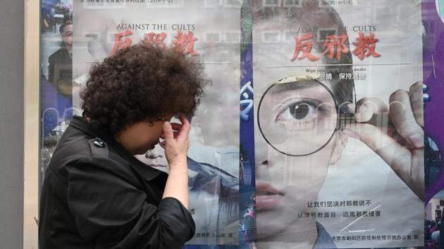 A woman walks past anti-cult posters. Top officials “see Falungong, first and foremost, as an ideological and political threat”, Maria Cheung, a University of Manitoba professor, told AFP. The demonstration had been the biggest in Beijing since the Tiananmen Square sit-in in 1989. Following it, Chinese authorities launched a special security bureau known as the “610 office” to suppress and monitor Falun Gong. (Greg Baker / AFP)