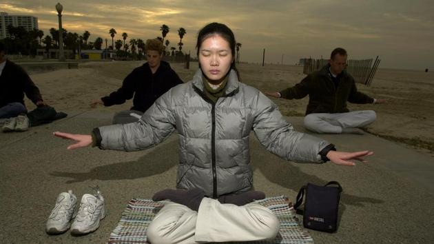 Early morning Falun Gong exercises at Santa Monica State Beach on March 3, 2001 in Santa Monica, California. While Falungong survives underground in mainland China, it has swelled among the Chinese diaspora, as followers have fled overseas in search of asylum. Falungong is practised in over 70 countries, according to Falun Dafa Info Centre, the group’s press office. (David McNew / Newsmakers / Getty Images)