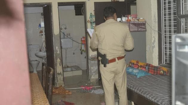 A police officer investigates the house where a man killed his wife and three children, at Gyan Khand 4, Indirapuram, in Ghaziabad, on Sunday, April 21, 2019.(Sakib Ali / HT Photo)