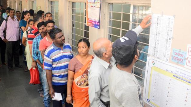 People are seen cross checking their names on the electoral list at Vivekananda School, Ghorpadi  (Shankar Narayan/HT PHOTO) 