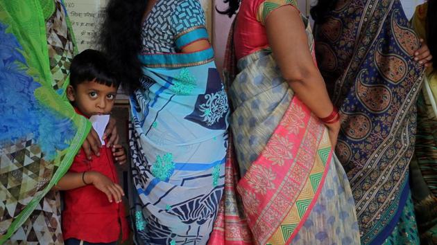 A boy looks on, queued with women waiting to cast votes the outskirts of Pune. Bharatiya Janata Party chief Amit Shah is making his Lok Sabha election debut from Gandhinagar and Congress President Rahul Gandhi enters the contest from Wayanad today.The BJP will aim to defend the 62 of the 117 third phase seats it won in 2014, its performance in this phase crucial in deciding its political fortunes. (Francis Mascarenhas / REUTERS) A boy looks on, queued with women waiting to cast votes the outskirts of Pune. Bharatiya Janata Party chief Amit Shah is making his Lok Sabha election debut from Gandhinagar and Congress President Rahul Gandhi enters the contest from Wayanad today.The BJP will aim to defend the 62 of the 117 third phase seats it won in 2014, its performance in this phase crucial in deciding its political fortunes. (Francis Mascarenhas / REUTERS)