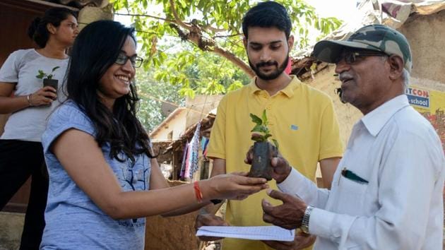 Volunteers of ‘Being Volunteer’ group gifted tulsi (basil) saplings to voters in Baner on Tuesday. (Milind Saurkar/HT Photo) 