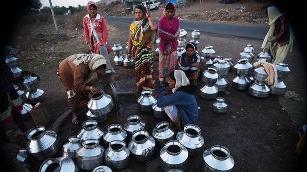 On an average, a woman from Ghanichamata works close to 20 hours a day. Of this, she dedicates more than four hours to filling up 10 to 12 pots of drinking water at this hand pump. Gayatri Jondhale, 35, who works on a farm in the neighbouring village, says she is at the hand pump as early as 2am every day, managing on just 3 hours of sleep a day. (Pramod Thakur / HT Photo) 
