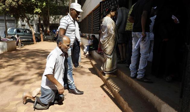 A physically challenged man on his was to a polling booth at Savitribai Phule Vidyalaya, Bhawani peth. (Rahul Raut/HT PHOTO) 