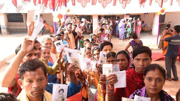 Odisha, India-April 18, 2019: Voters show their identity cards as they stand in queues to cast their votes during the second phase of the general elections at a polling station, in Kandhamal district, Odisha, India, April 18, 2019. (Photo by Arabinda Mahapatra / Hindustan Times)