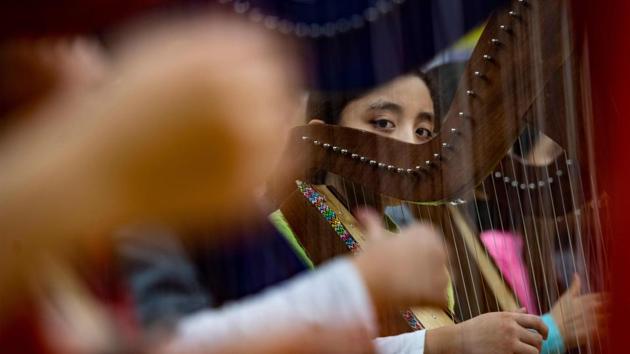 Daisy Mendez, a harpist, performs during the String Fling concert. Even if music is not a career option for most of the students enrolled in OrchKids, the program offers them a perspective that is not always available to inner-city kids, especially in Charm City. (Jim Watson / AFP) Daisy Mendez, a harpist, performs during the String Fling concert. Even if music is not a career option for most of the students enrolled in OrchKids, the program offers them a perspective that is not always available to inner-city kids, especially in Charm City. (Jim Watson / AFP)