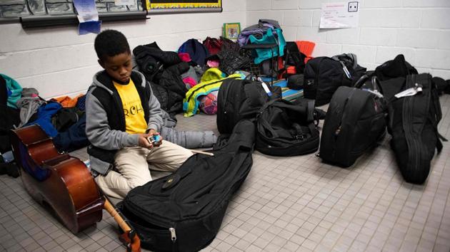 Diyon Gross, a cellist in the Baltimore Symphony Orchestra's OrchKids program, arrives for practice. Those behind OrchKids remain optimistic. In all, 1,300 children -- from grade school to high school -- are enrolled in the program, which offers them free music education, four afternoons a week after school. (Jim Watson / AFP) Diyon Gross, a cellist in the Baltimore Symphony Orchestra's OrchKids program, arrives for practice. Those behind OrchKids remain optimistic. In all, 1,300 children -- from grade school to high school -- are enrolled in the program, which offers them free music education, four afternoons a week after school. (Jim Watson / AFP)