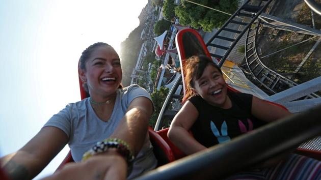 Oriana Contreras and her niece ride a roller coaster at Italo Americano amusement park in Caracas. Strife has similarly not stopped Joaquin Nino, a cash-strapped 35-year-old father of two, from taking his kids to an amusement park in southern Caracas. “We have to work miracles just to have some fun,” Nino said. (Ivan Alvarado / REUTERS) Oriana Contreras and her niece ride a roller coaster at Italo Americano amusement park in Caracas. Strife has similarly not stopped Joaquin Nino, a cash-strapped 35-year-old father of two, from taking his kids to an amusement park in southern Caracas. “We have to work miracles just to have some fun,” Nino said. (Ivan Alvarado / REUTERS)