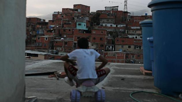 Andrew rides a small tricycle on the rooftop of his family house in Caracas. But in a country where the monthly minimum wage amounts to just $6 per month, the $15-$20 a day trip to the beach can require months of savings and advance planning. Martinez, who said he used to take the 40-kilometer trip to the beach frequently, said it was the first time he had gone in a year. (Ivan Alvarado / REUTERS) Andrew rides a small tricycle on the rooftop of his family house in Caracas. But in a country where the monthly minimum wage amounts to just $6 per month, the $15-$20 a day trip to the beach can require months of savings and advance planning. Martinez, who said he used to take the 40-kilometer trip to the beach frequently, said it was the first time he had gone in a year. (Ivan Alvarado / REUTERS)