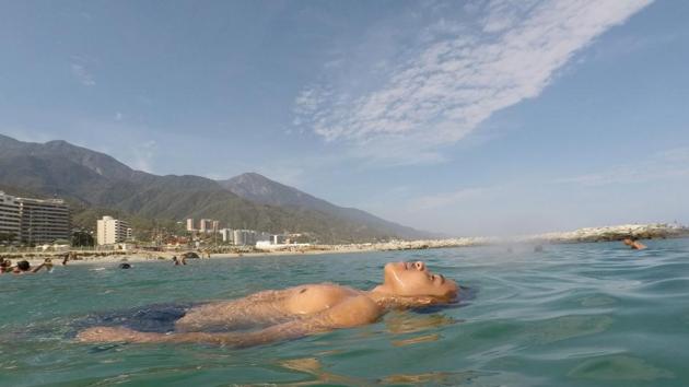Victor floats in the sea as he spends a day at Coral beach, La Guaira, near Caracas, Venezuela, March 23, 2019. (Ivan Alvarado / REUTERS) Victor floats in the sea as he spends a day at Coral beach, La Guaira, near Caracas, Venezuela, March 23, 2019. (Ivan Alvarado / REUTERS)