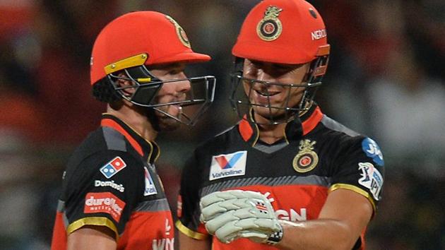 Royal Challengers Bangalore batsman Marcus Stoinis (R) greets his team mate AB De Villiers.(AFP)