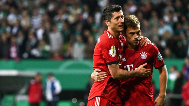 Bayern Munich's Polish forward Robert Lewandowski (L) and Bayern Munich's German midfielder Joshua Kimmich react after the German Cup (DFB Pokal) semi-final football match SV Werder Bremen vs Bayern Munich in Bremen(AFP)