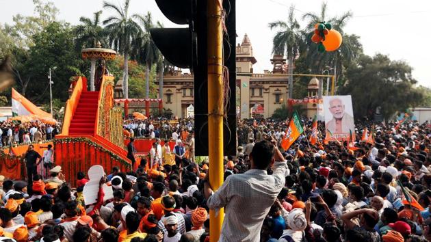 Supporters of Prime Minister Modi await his arrival during a roadshow in Varanasi. Modi will garland the statue of Banaras Hindu University founder Pandit Madan Mohan Malviya before starting a roadshow, a party leader said. On Friday, he will file nomination papers for the seat he won by bagging more than half the votes polled, 56%, and won with a massive margin of 3.37 lakh votes in 2014. (Adnan Abidi / REUTERS) Supporters of Prime Minister Modi await his arrival during a roadshow in Varanasi. Modi will garland the statue of Banaras Hindu University founder Pandit Madan Mohan Malviya before starting a roadshow, a party leader said. On Friday, he will file nomination papers for the seat he won by bagging more than half the votes polled, 56%, and won with a massive margin of 3.37 lakh votes in 2014. (Adnan Abidi / REUTERS)