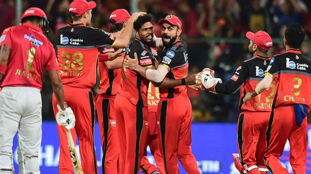 RCB Skipper Virat Kohli and bowler Umesh Yadav celebrate with teammates after dismissal of KXIP batsman Chris Gayle. (PTI) RCB Skipper Virat Kohli and bowler Umesh Yadav celebrate with teammates after dismissal of KXIP batsman Chris Gayle. (PTI)