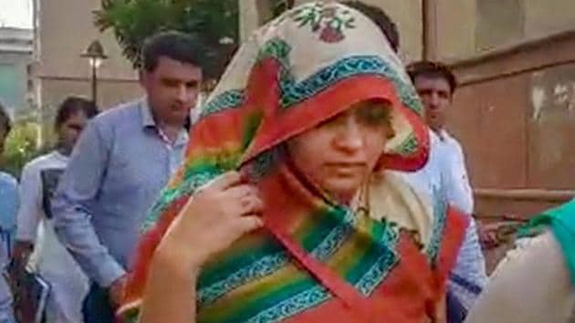 Apoorva Shukla Tiwari, accused of murdering her husband Rohit Shekhar Tiwari, being taken away after she was produced in a court in New Delhi.(PTI)