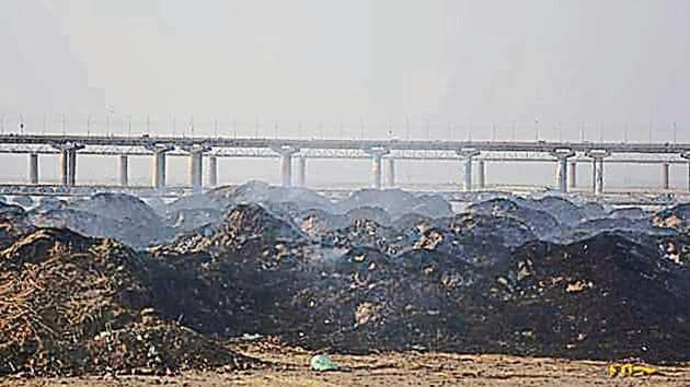 Solid waste being burnt at Parade Ground near Sangam in Prayagraj.(HT Photo)