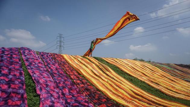 A worker throws a cloth during a drying process at Sukoharjo near Solo, Central Java province, Indonesia. (Mohammad Ayudha / Antara Foto via REUTERS) A worker throws a cloth during a drying process at Sukoharjo near Solo, Central Java province, Indonesia. (Mohammad Ayudha / Antara Foto via REUTERS)