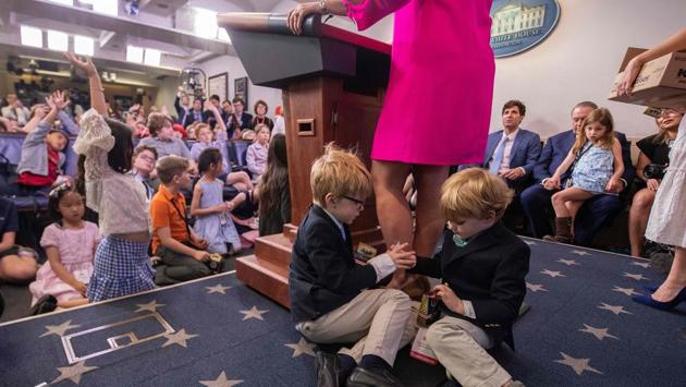 White House Press Secretary Sarah Sanders’s sons Huck (L) and George (R) sit at her feet as she presides over a briefing with children of journalists and White House staff during “Bring Our Sons and Daughters to Work Day” at the White House in Washington, DC. (Jim Watson / AFP) White House Press Secretary Sarah Sanders’s sons Huck (L) and George (R) sit at her feet as she presides over a briefing with children of journalists and White House staff during “Bring Our Sons and Daughters to Work Day” at the White House in Washington, DC. (Jim Watson / AFP)