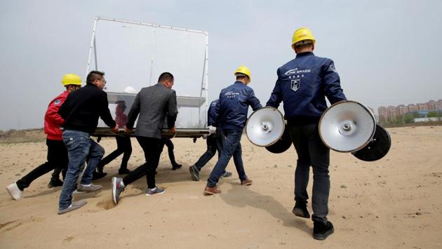 People carry a table, used as the launch control console for a LinkSpace test launch. The company hopes to charge no more than 30 million yuan ($4.48 million) per launch, Hu told Reuters. That is a fraction of the $25 million to $30 million needed for a launch on a Northrop Grumman Innovation Systems Pegasus, a commonly used small rocket. The Pegasus is launched from a high-flying aircraft and is not reusable. (Jason Lee / REUTERS)