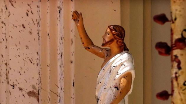 Bloodstains a Jesus Christ statue at the St. Sebastian's Church after a blast in Negombo, north of Colombo, Sri Lanka. (AP FIle) Bloodstains a Jesus Christ statue at the St. Sebastian's Church after a blast in Negombo, north of Colombo, Sri Lanka. (AP FIle)