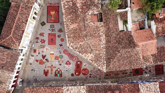 Sawdust rugs decorate a street in the Brazilian historic city of Ouro Preto, Minas Gerais State before an Easter procession representing the resurrection of Christ. The streets were decorated by locals and tourists who used about 60 tons of coloured sawdust. (Douglas Magno / AFP) Sawdust rugs decorate a street in the Brazilian historic city of Ouro Preto, Minas Gerais State before an Easter procession representing the resurrection of Christ. The streets were decorated by locals and tourists who used about 60 tons of coloured sawdust. (Douglas Magno / AFP)