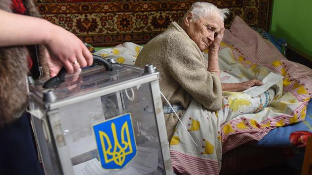 Maria Pavlyshyn, 99, examines her ballot paper in her house, some 15 km from western Ukrainian city of Lviv, during the second round of Ukraine’s presidential election. (Yuri Dyachyshyn / AFP) Maria Pavlyshyn, 99, examines her ballot paper in her house, some 15 km from western Ukrainian city of Lviv, during the second round of Ukraine’s presidential election. (Yuri Dyachyshyn / AFP)