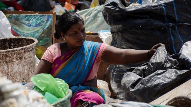 A Swach sanitary worker sorting garbage at the Balewadi dump yard without wearing basic equipment like hand gloves and mask. (HT File Photo) A Swach sanitary worker sorting garbage at the Balewadi dump yard without wearing basic equipment like hand gloves and mask. (HT File Photo)