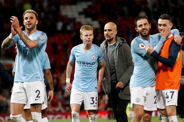 FILE PHOTO: Manchester City manager Pep Guardiola and Oleksandr Zinchenko after the match(Action Images via Reuters)