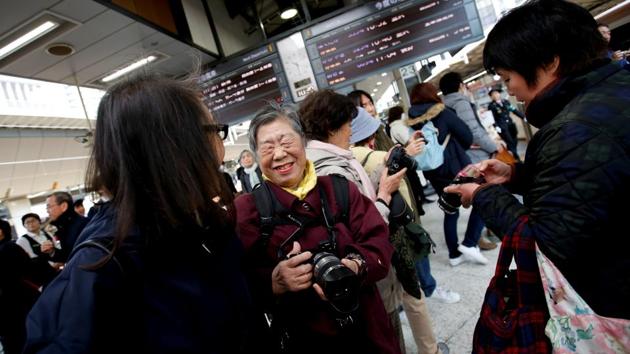 Fumiko Shirataki (C) and her friends react after taking photographs of Japan's Emperor Empress at Tokyo Station. “You can’t get good pictures then - and if the camera lens gets wet, it might get damaged. I really worry about that,” said Shirataki, 78, who has spent the last 26 years following and photographing Emperor Akihito, Empress Michiko and especially Crown Princess Masako. (Issei Kato / REUTERS) Fumiko Shirataki (C) and her friends react after taking photographs of Japan's Emperor Empress at Tokyo Station. “You can’t get good pictures then - and if the camera lens gets wet, it might get damaged. I really worry about that,” said Shirataki, 78, who has spent the last 26 years following and photographing Emperor Akihito, Empress Michiko and especially Crown Princess Masako. (Issei Kato / REUTERS)
