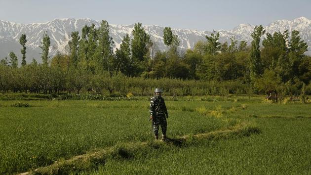 An Indian paramilitary soldier stands on a paddy field guarding outside a polling station during the third phase of India’s general elections, at Verinag, Jammu and Kashmir. (Mukhtar Khan / AP) An Indian paramilitary soldier stands on a paddy field guarding outside a polling station during the third phase of India’s general elections, at Verinag, Jammu and Kashmir. (Mukhtar Khan / AP)