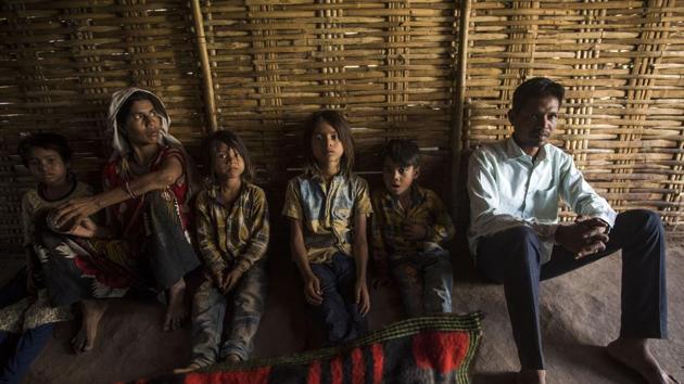 Vasant Bija Vasave (extreme right) is first on the state's poll list, but his village, Manibeli, has no roads or mobile connectivity. On Monday, villagers will go by boat to cast votes. (Pratik Chorge/HT Photo) Vasant Bija Vasave (extreme right) is first on the state's poll list, but his village, Manibeli, has no roads or mobile connectivity. On Monday, villagers will go by boat to cast votes. (Pratik Chorge/HT Photo)
