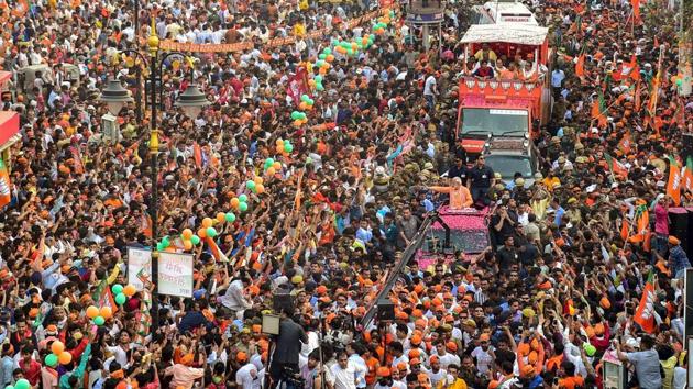 Prime Minister Narendra Modi waves at supporters during his roadshow, a day ahead of filing his nomination papers for the Lok Sabha polls, in Varanasi, Uttar Pradesh. (Manvender Vashist / PTI) Prime Minister Narendra Modi waves at supporters during his roadshow, a day ahead of filing his nomination papers for the Lok Sabha polls, in Varanasi, Uttar Pradesh. (Manvender Vashist / PTI)