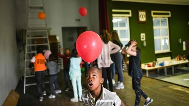 A young refugee plays with a balloon. Since 2016, Ferrette has permanently taken in about 80 asylum seekers -- half of them children -- from places as far-flung as Afghanistan, Sudan and Armenia. All of them are hoping to be recognised as refugees -- or at the very least, that France will grant them “subsidiary protection”, the status granted to asylum seekers who do not qualify as refugees. (Sebastien Bozon / AFP) 