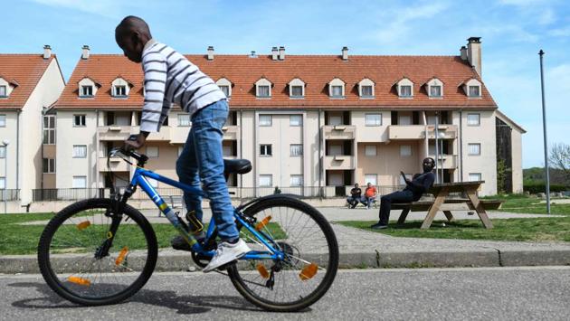 A boy rides a bike as refugees wait in front of a temporary accommodation for asylum seekers. The only thing about Ferrette, Djoe Kabuka, a Congolese national says, is the lack of public transport and the need to travel to Mulhouse, a town 30 kilometres away, to find the sort of foods the refugees are used to. The other thing is the weather. “It gets very cold and very hot here,” smiled Abundance, a teenager from Nigeria. (Sebastien Bozon / AFP) 