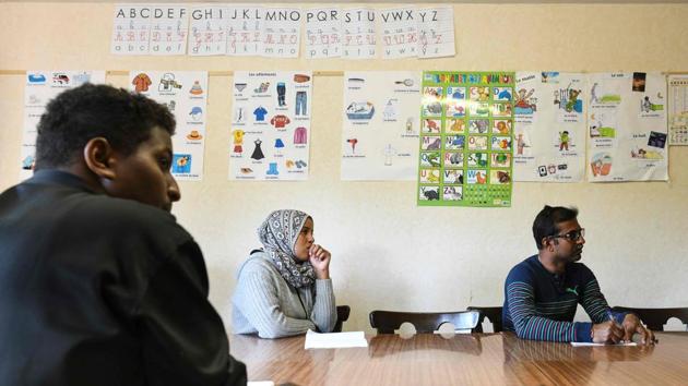 Refugees listen during a French lesson at a temporary accommodation for asylum seekers. While some protested, other residents came together to help, with the emergence of a group called “Neighbours Around the World” that offered them French lessons, access to a games library, cooking classes and even lifts to the hospital. (Sebastien Bozon / AFP) 